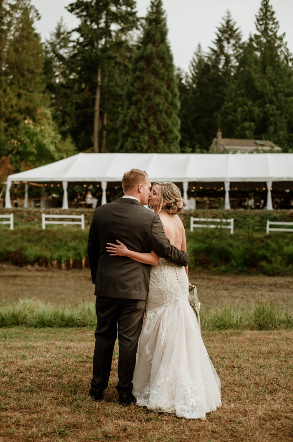 bride and groom in front of puska properties tent