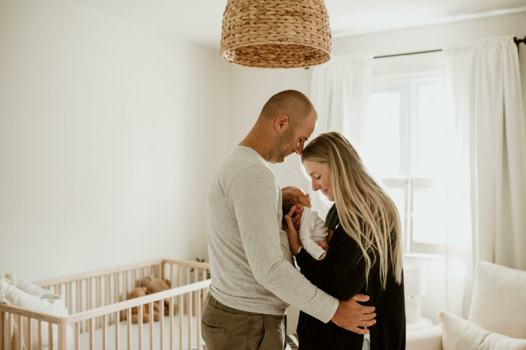 parents with baby and dog in the nursery