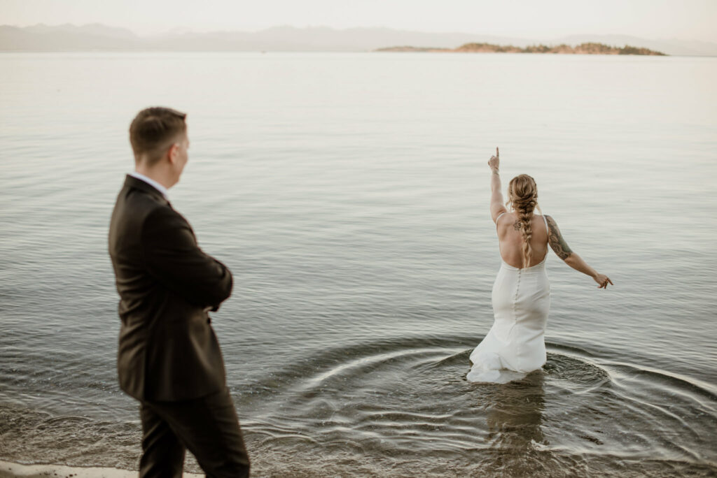 One of the brides gets in the water during our sunset photos