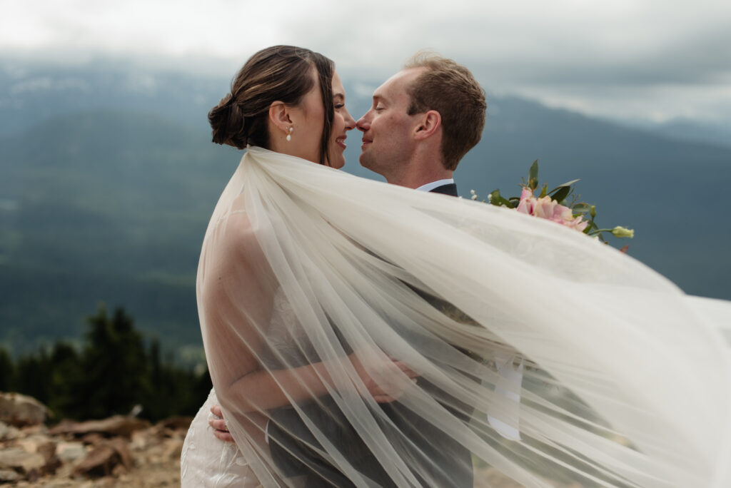 bride and groom at the top of Mount Washington