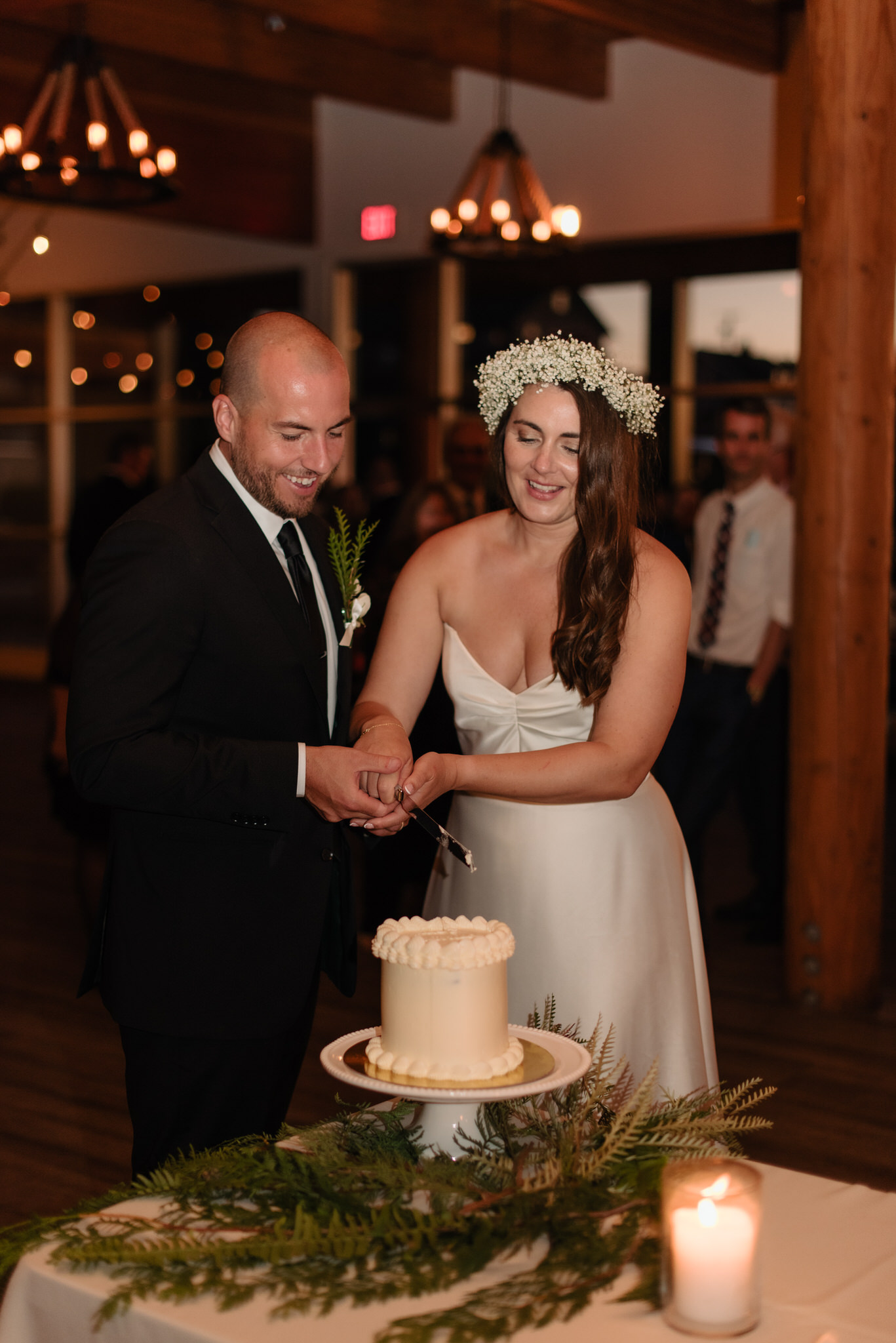 The bride and groom cut their cake inside the Shore Pier venue