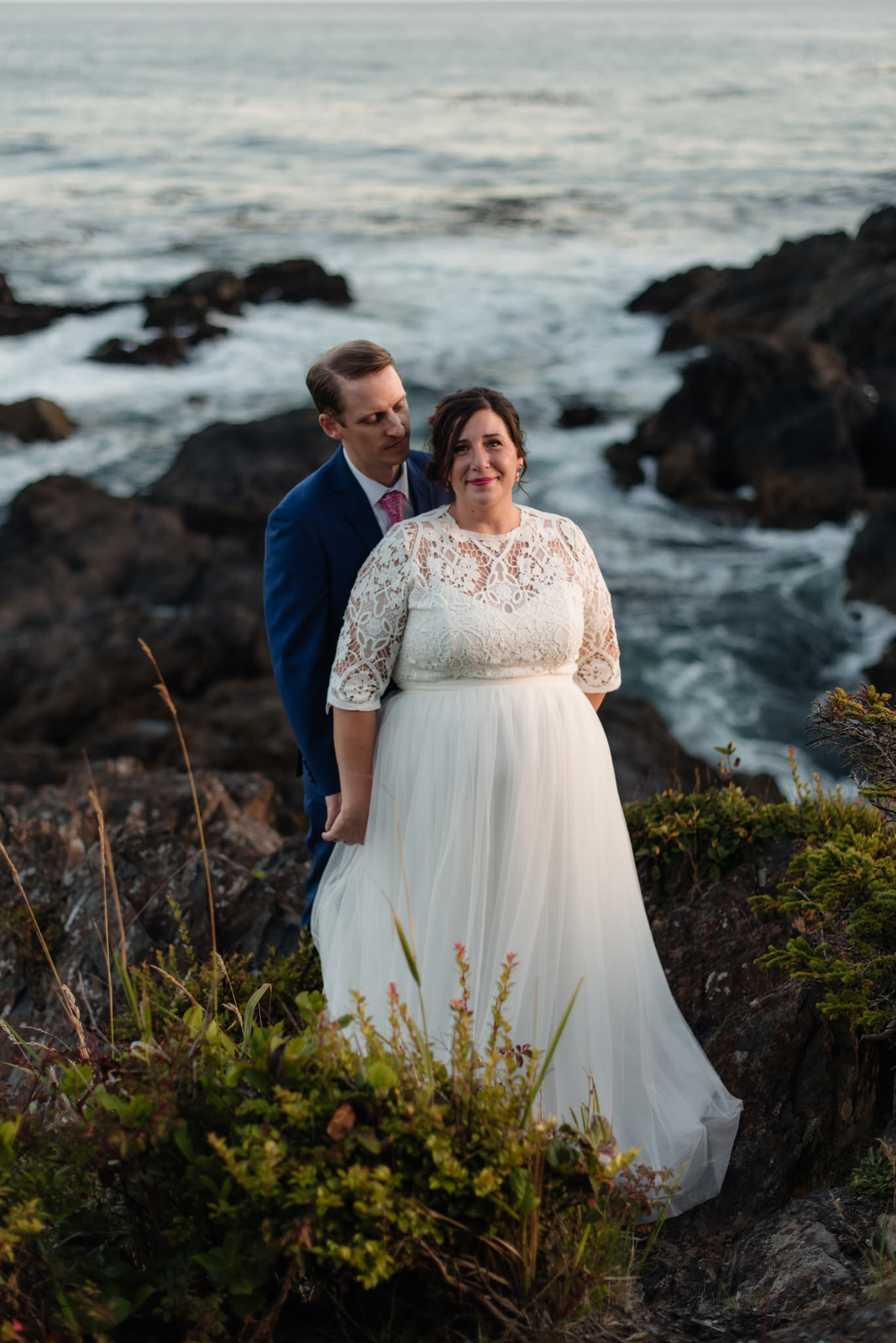 The bride and groom on the rocks during golden hour at their Black Rock wedding