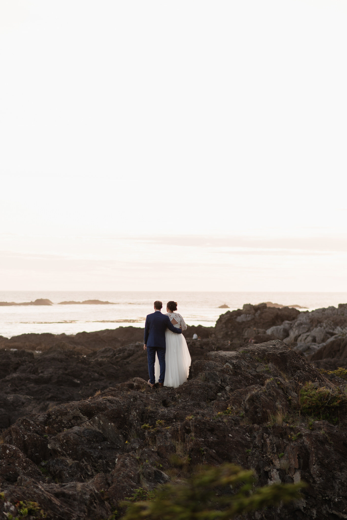 The bride and groom on the rocks during golden hour at their Black Rock wedding