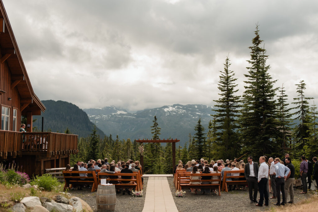 Guests wait for the wedding ceremony to start at Mount Washington Raven Lodge
